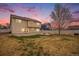 Picture of the home's backyard featuring lawn area, concrete patio, and fire pit, great for outdoor entertaining at 5210 Roadrunner Ave, Firestone, CO 80504
