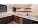 Basement bar area with granite countertops, dark cabinetry, and beverage cooler at 5210 Roadrunner Ave, Firestone, CO 80504