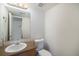 Half bathroom with a single sink vanity, toilet, and mirror at 5210 Roadrunner Ave, Firestone, CO 80504