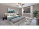 Comfortable bedroom with soft lighting, a ceiling fan and a large window with curtains at 5210 Roadrunner Ave, Firestone, CO 80504