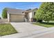 Charming two-story home with a well-manicured lawn and a two car garage on a sunny day at 5210 Roadrunner Ave, Firestone, CO 80504