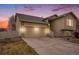 Lovely home featuring stone accents, a two-car garage, and an inviting entrance with manicured front lawn at 5210 Roadrunner Ave, Firestone, CO 80504