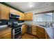 Stylish kitchen featuring stainless steel appliances and ample wood cabinetry for all your cooking essentials at 5210 Roadrunner Ave, Firestone, CO 80504