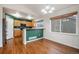 Charming kitchen and dining area with natural wood cabinetry, a breakfast bar, and lots of natural light at 5210 Roadrunner Ave, Firestone, CO 80504