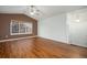 Spacious living room featuring vaulted ceilings, wood floors, abundant natural light, and a ceiling fan at 5210 Roadrunner Ave, Firestone, CO 80504