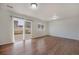 Bright living room with wood floors and sliding glass doors leading to the backyard at 5210 Roadrunner Ave, Firestone, CO 80504