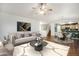 Cozy living room with modern decor, featuring a large flat-screen TV, plush seating, and an open layout at 5210 Roadrunner Ave, Firestone, CO 80504