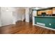 Inviting living area showcases hardwood floors and seamless flow into the kitchen, enhancing the living space at 5210 Roadrunner Ave, Firestone, CO 80504