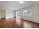 Well-lit living room featuring wood floors, window and sliding glass doors to the outside at 5210 Roadrunner Ave, Firestone, CO 80504