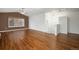 Spacious living room featuring vaulted ceilings, wood floors, abundant natural light, and a ceiling fan at 5210 Roadrunner Ave, Firestone, CO 80504