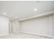 Spacious basement with neutral carpet and lighting, ideal for customization at 2858 W Parkside Pl, Denver, CO 80221