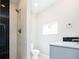 Bathroom boasts tile shower with black accent, gray vanity, and good natural lighting at 2858 W Parkside Pl, Denver, CO 80221