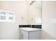 Bright bathroom includes gray vanity, white countertop, and a large mirror reflecting window light at 2858 W Parkside Pl, Denver, CO 80221