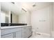 Modern bathroom with double vanity, sleek fixtures, subway tile, and glass-enclosed shower at 2858 W Parkside Pl, Denver, CO 80221