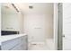 Modern bathroom with double vanity, sleek fixtures, subway tile, and glass-enclosed shower at 2858 W Parkside Pl, Denver, CO 80221