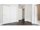 Bedroom with dark hardwood floors, a closet with sliding doors, and open doorway to ensuite at 2858 W Parkside Pl, Denver, CO 80221