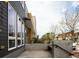 Contemporary townhome showcasing large windows, modern siding, and a concrete front patio area at 2858 W Parkside Pl, Denver, CO 80221
