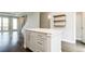 Modern kitchen island featuring drawers, cabinets, stone countertop, and hardwood floors throughout at 2858 W Parkside Pl, Denver, CO 80221