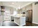 Modern kitchen featuring stainless steel appliances, stone countertops, and an island with bar seating at 2858 W Parkside Pl, Denver, CO 80221