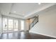 Bright living room featuring dark hardwood floors, lots of natural light, and modern staircase at 2858 W Parkside Pl, Denver, CO 80221
