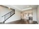 Bright living room with hardwood floors, a modern staircase, and an open concept leading to the kitchen at 2858 W Parkside Pl, Denver, CO 80221