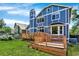 Beautiful backyard with a large lawn, gardens, and a wooden deck, ideal for outdoor living at 9682 Hemlock Ct, Highlands Ranch, CO 80130