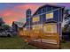 Charming backyard with a large lawn, gardens, and a wooden deck at sunset, ideal for outdoor living at 9682 Hemlock Ct, Highlands Ranch, CO 80130