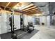 The basement workout area features exposed wood ceiling and fitness equipment at 9682 Hemlock Ct, Highlands Ranch, CO 80130