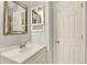 Bathroom with light blue walls, a mirrored vanity, and a white door at 9682 Hemlock Ct, Highlands Ranch, CO 80130