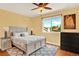 Bright bedroom features a large window and warm yellow walls at 9682 Hemlock Ct, Highlands Ranch, CO 80130