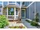 Cozy front porch area with a bench and chairs, stone accents, and inviting entrance at 9682 Hemlock Ct, Highlands Ranch, CO 80130