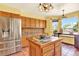 Bright kitchen features stainless steel refrigerator and breakfast table with natural light at 9682 Hemlock Ct, Highlands Ranch, CO 80130