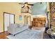 Open-concept living area with a stone fireplace, hardwood floors, and access to the kitchen at 9682 Hemlock Ct, Highlands Ranch, CO 80130