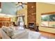 Bright living area with a stone fireplace, hardwood floors, and access to an outdoor deck at 9682 Hemlock Ct, Highlands Ranch, CO 80130