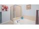 Cozy tub and shower in bathroom with decorative tile and modern fixtures at 13706 Legend Trail # 104, Broomfield, CO 80023
