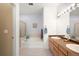 Well-lit bathroom with double vanity, tub, and shower featuring modern fixtures at 13706 Legend Trail # 104, Broomfield, CO 80023