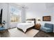 Bright and spacious bedroom with large window, ceiling fan, and comfortable furnishings at 13706 Legend Trail # 104, Broomfield, CO 80023