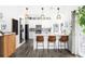 Well-lit kitchen featuring modern white cabinets, stainless appliances, and a sleek breakfast bar at 13706 Legend Trail # 104, Broomfield, CO 80023