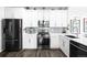 Sleek kitchen with white cabinets, stainless steel appliances, and stylish backsplash at 13706 Legend Trail # 104, Broomfield, CO 80023