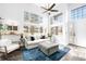 Bright living room boasts soaring windows, contemporary furnishings, and an inviting atmosphere at 13706 Legend Trail # 104, Broomfield, CO 80023