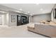 Spacious basement with dark built ins for media and an elegant sofa at 18036 E 99Th Ave, Commerce City, CO 80022