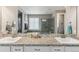 Bright bathroom with dual sinks, granite countertops, and a large vanity mirror at 18036 E 99Th Ave, Commerce City, CO 80022