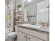 Bathroom featuring shower, vanity, toilet, and natural light at 18036 E 99Th Ave, Commerce City, CO 80022