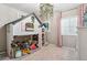 Bedroom with playhouse bed, pink rug, chandelier, pink curtains, and window at 18036 E 99Th Ave, Commerce City, CO 80022