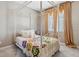 Cozy bedroom with bright, white furniture and colorful crochet blanket at 18036 E 99Th Ave, Commerce City, CO 80022
