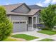 This exterior shot showcases the covered porch, beautiful stone accents, and well-kept lawn at 18036 E 99Th Ave, Commerce City, CO 80022