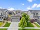Charming gray home with a well-manicured lawn and lovely landscaping creating wonderful curb appeal at 18036 E 99Th Ave, Commerce City, CO 80022