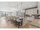 Bright eat-in kitchen featuring granite counters, a kitchen island with bar seating, and stainless appliances at 18036 E 99Th Ave, Commerce City, CO 80022