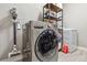 Functional laundry room with modern washer, dryer, and storage shelving at 18036 E 99Th Ave, Commerce City, CO 80022