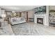 Open-concept living room featuring a fireplace, modern decor, and hardwood floors at 18036 E 99Th Ave, Commerce City, CO 80022